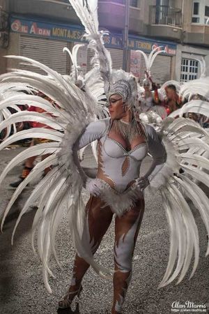 Lady in feathered costume at Aguilas Carnival