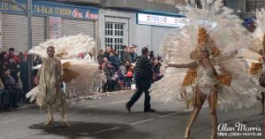 Performers in white feather costumes, Aguilas Carnival.