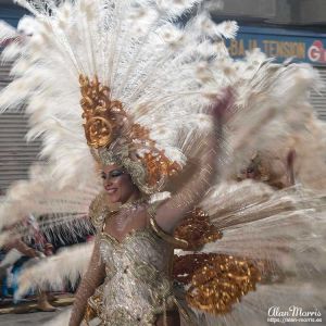 Lady in a white feather costume at Aguilas Carnival.