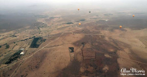Balloons float in the sky above the desert. Balloons float in the sky above the desert.