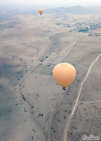 A hot air balloon below but close to the air balloon I am in over the desert. A hot air balloon below but close to the air balloon I am in over the desert.