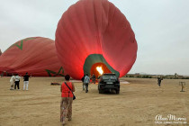 Lisa Biles in the desert, in front of an air balloon.