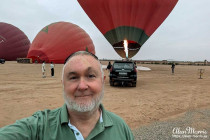 Alan Morris in the desert in front of the balloon he went for a flight in.