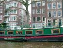 Canal boat on a canal running through Amsterdam.