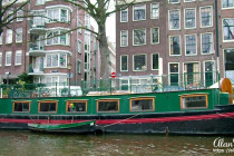 Canal boat on a canal running through Amsterdam.