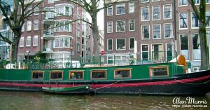 Canal boat on a canal running through Amsterdam.