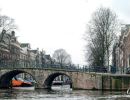 A stone bridge over a canal in Amsterdam.