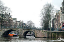 A stone bridge over a canal in Amsterdam.