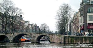 A stone bridge over a canal in Amsterdam.