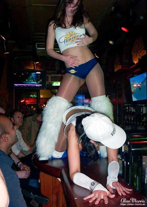 Waitress dancing on the bar at Teasers restaurant/bar in Amsterdam.