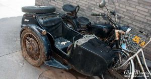 Motorbike & sidecar parked outside a home in the Beijing Hutongs.