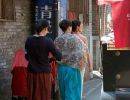 Chinese ladies walking through the Beijing Hutongs.