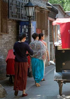 Chinese ladies walking through the Beijing Hutongs.