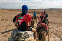 Camel train riding through the desert near Marrakech, Morocco.