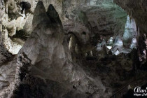 Two stalagmites growing up look like mountains in a Mars landscape.