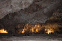 Large cave in Carlsbad Caverns with a lit path around the walls.