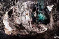 Coloured lights form eery patterns and shapes on Stalactites and stalagmites in Carlsbad Caverns.