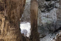 Large stalagmite growing up towards the ceiling of a cave at Carlsbad Caverns in New Mexico.