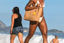 Ladies walking along Copacabana Beach.