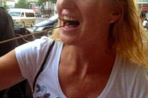 Melanie Lunn eating a scorpion in a Beijing food market.