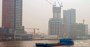 Container ship sailing up the Huangpu River in Shanghai. Container ship sailing up the Huangpu River in Shanghai.