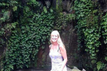 Melanie Lunn next to a dragon's tail.
