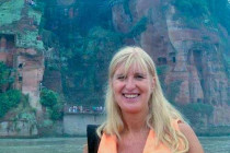 Melanie Lunn on a boat at the Min & Dadu Rivers by the Giant Leshan Buddha.