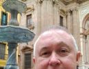 Alan Morris, next to a fountain outside the Malaga Cathedral.