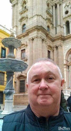 Alan Morris, next to a fountain outside the Malaga Cathedral.