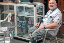 Alan Morris sat at a table in the road outside this shop in the medina of Marrakech.