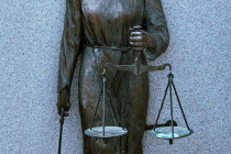 Monument in Denver City Park. Showing the scales of justice.