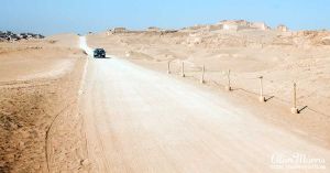 Car driving along dirt road at the Pachacamac complex.