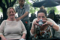 Tracy Good having a massage while Liz Conroy drinks Jasmine tea.