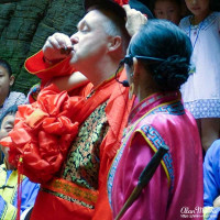 Alan Morris drinks some rice wine to toast his new wife. Alan Morris drinks some rice wine to toast his new wife.