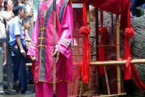 Matchmaker talks to the seated crowd at the Tribe of the 3 Gorges.
