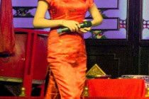 Beautiful compere introduces the Sichuan Opera & Folk Art show.