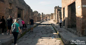 Remains of homes on either side of a cobbled street in Pompeii.