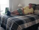 Alan Morris on his bed at his apartment in the Villages of Seaport.