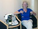 Jean Morris drinking champagne in the cabin on the Queen Mary II.