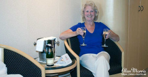 Jean Morris drinking champagne in the cabin on the Queen Mary II.