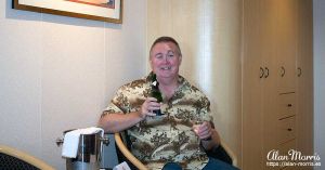 Alan Morris drinking Champagne in the cabin on the Queen Mary II.