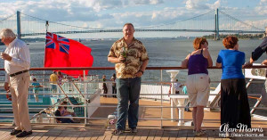 Alan Morris, with a beer, on the deck of the Queen Mary II.