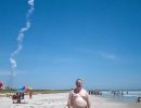 A rocket plume rises into the sky at Cape Canaveral behind Alan Morris.