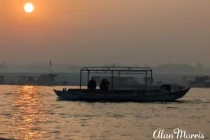 The sun coming up over a boat on the River Ganges at Varanasi.