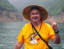 Alan Morris on a small boat that he sailed up the Shennong Stream on.