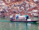 Man sailing his small boat along the Shennong Stream.