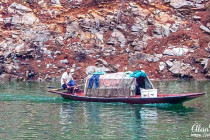 Man sailing his small boat along the Shennong Stream.