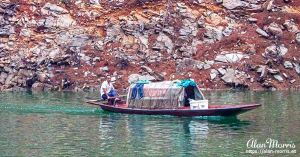 Man sailing his small boat along the Shennong Stream.