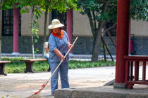 Groundskeeper sweeping leaves at the Small Wild Goose Pagoda