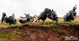 Bronze sculpture showing North American Plains Bison being herded towards a Bison Jump.